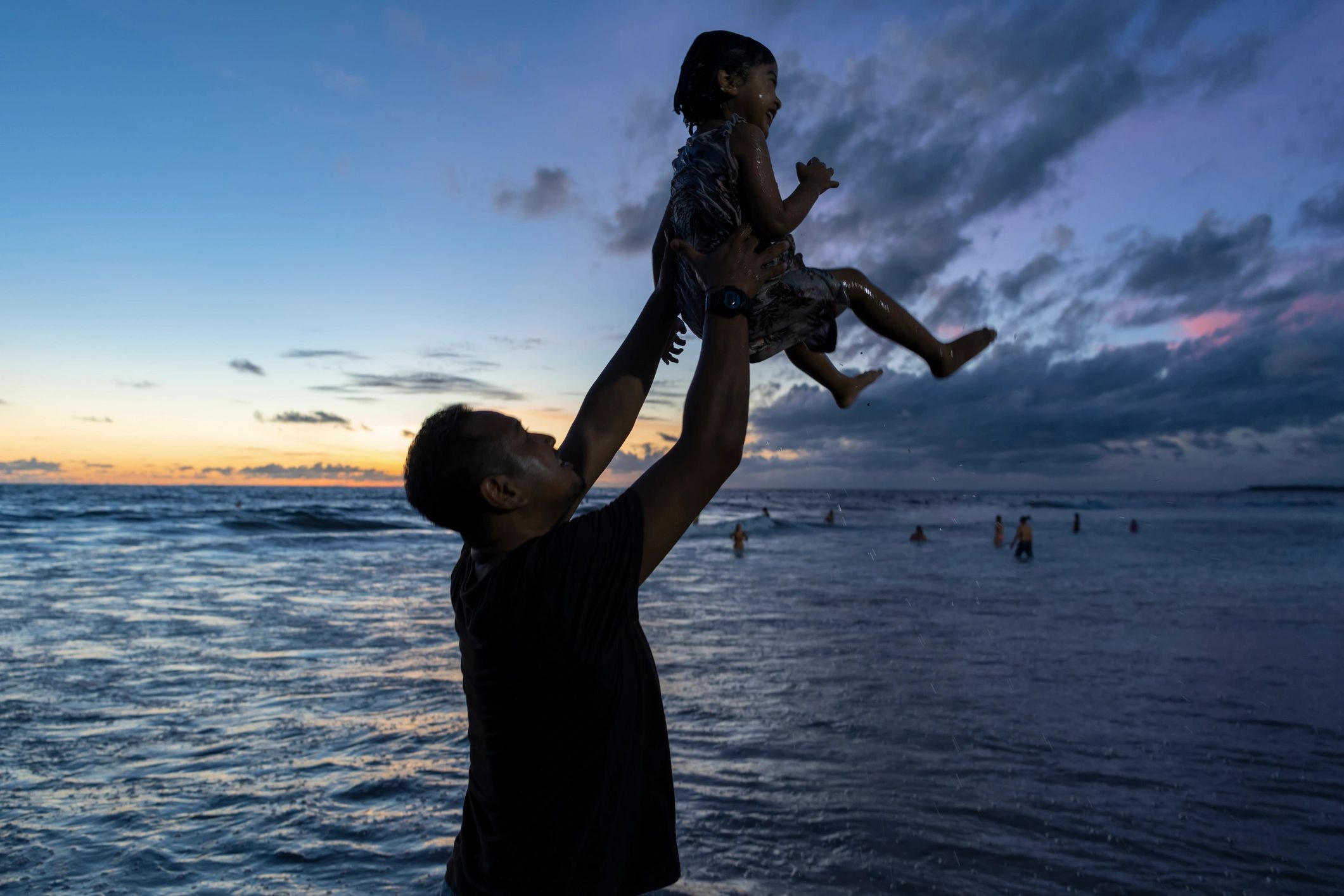 Father and child silhouette at the beach